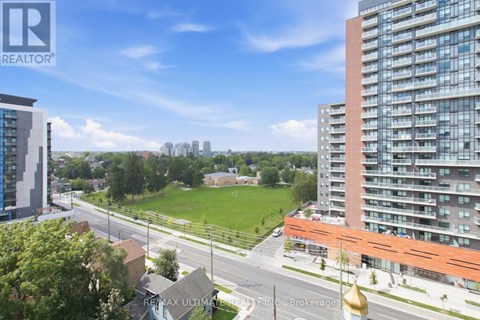 A cityscape with a mix of residential buildings and green spaces.