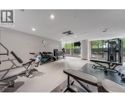 A gym with a variety of equipment including treadmills, weights, and exercise machines.