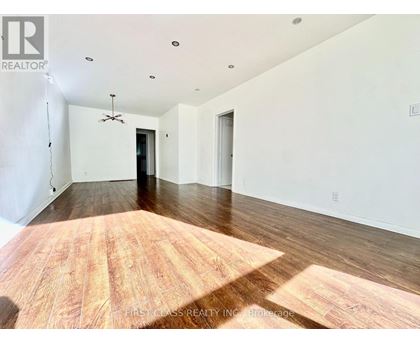 A room with wooden flooring and a ceiling fan.