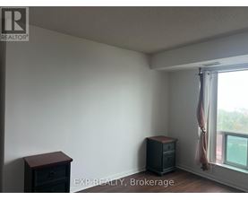 A room with a window and a wooden chest of drawers.