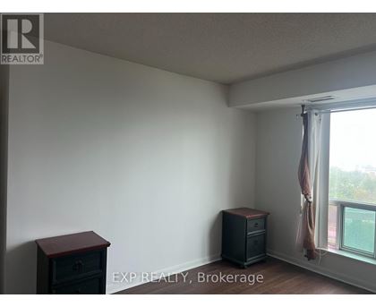 A room with a window and a wooden chest of drawers.
