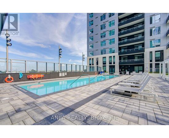 A swimming pool on a rooftop with a building in the background.