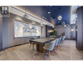 A modern dining room with a large table and chairs.