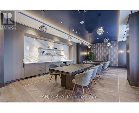 A modern dining room with a large table and chairs.
