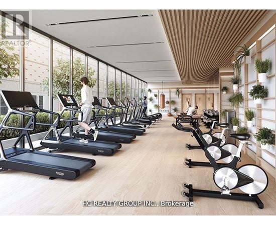 A gym with treadmills and a woman working out.