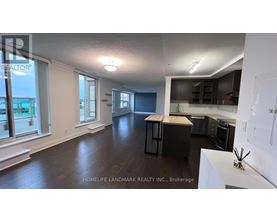 A realtor photo of a kitchen and living room.