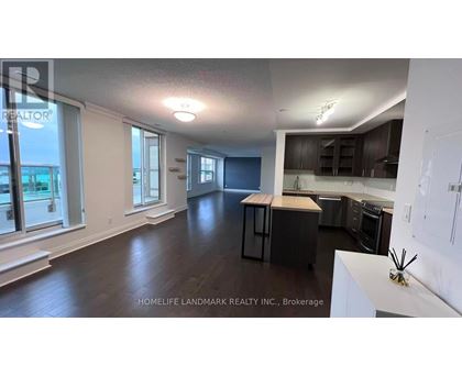 A realtor photo of a kitchen and living room.