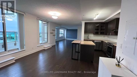 A realtor photo of a kitchen and living room.