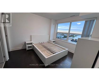 A bedroom with a large bed and a window overlooking a snowy landscape.