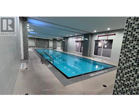 A swimming pool inside a building with a sign that says "REALTOR".