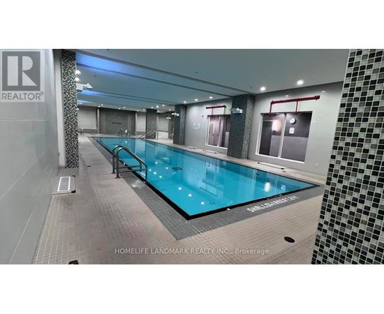 A swimming pool inside a building with a sign that says "REALTOR".
