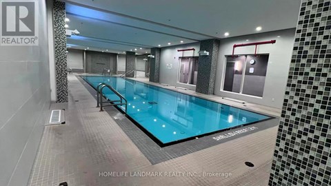 A swimming pool inside a building with a sign that says "REALTOR".
