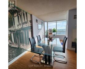 A dining room with a glass table and chairs.
