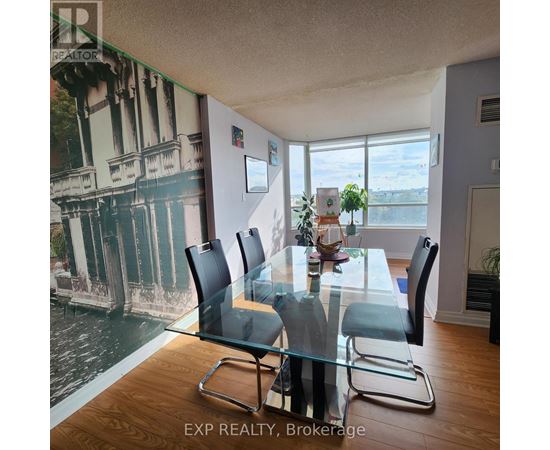 A dining room with a glass table and chairs.
