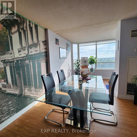 A dining room with a glass table and chairs.