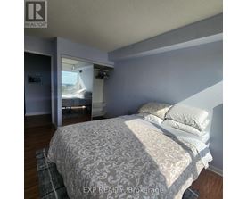 A bedroom with a large bed and a window.