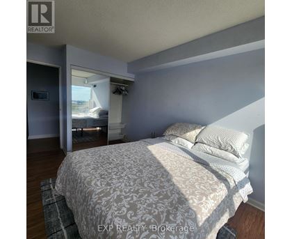 A bedroom with a large bed and a window.