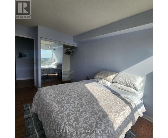 A bedroom with a large bed and a window.