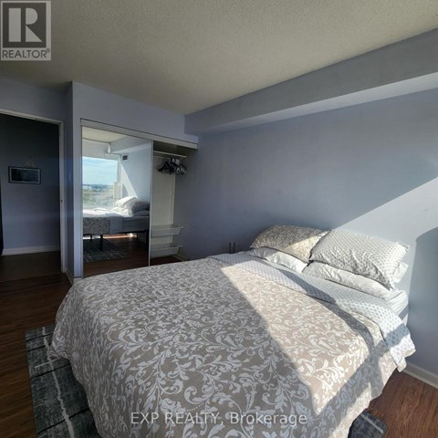 A bedroom with a large bed and a window.