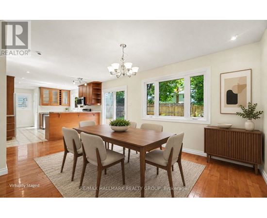 A dining room with a wooden table and chairs.