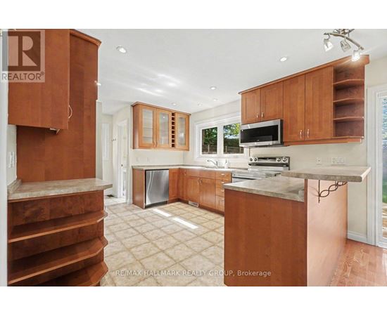 A kitchen with wooden cabinets and a stainless steel dishwasher.