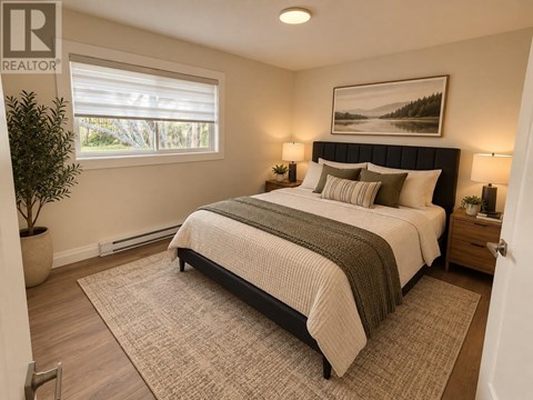 A bedroom with a large bed and a painting on the wall.