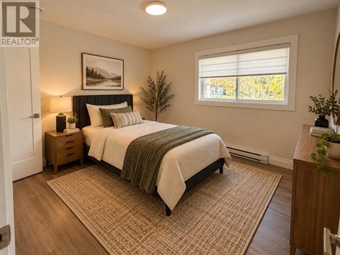 A bedroom with a bed, nightstands, and a window.