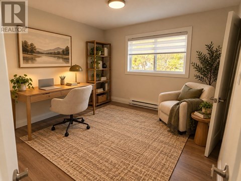 A room with a desk, chair, and a painting on the wall.