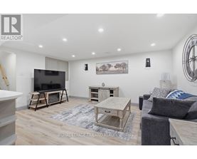 A living room with a flat screen TV and a wooden coffee table.
