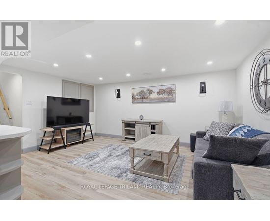 A living room with a flat screen TV and a wooden coffee table.