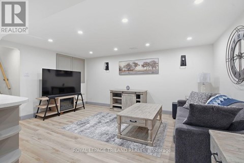 A living room with a flat screen TV and a wooden coffee table.