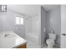 A white bathroom with a sink, toilet, and bathtub.