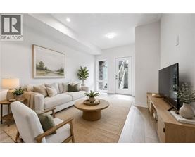 A living room with a couch, chair, and television.