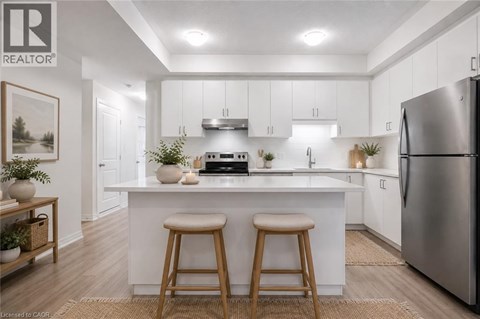 A modern kitchen with white cabinets and a large island.