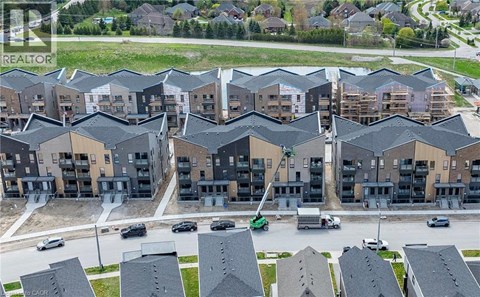 A large apartment complex with multiple buildings and cars parked in the driveways.
