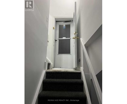 A white door with a glass window is at the end of a staircase.