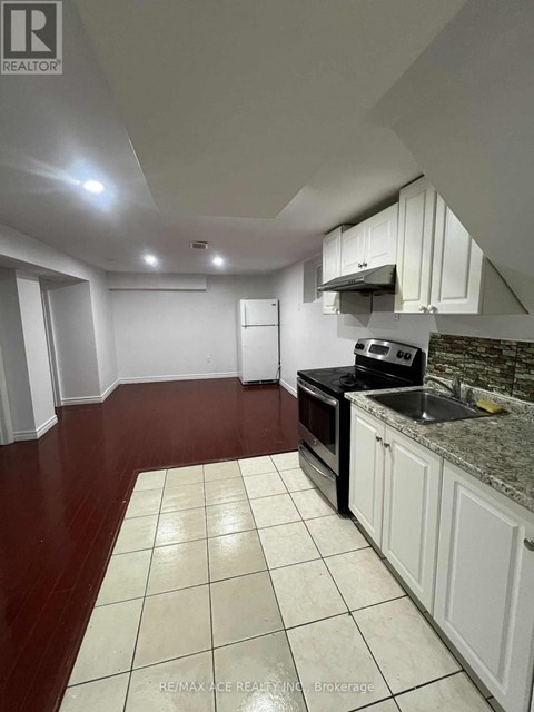 A kitchen with white cabinets and a black stove top oven.
