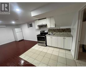 A kitchen with white cabinets and a black stove top oven.
