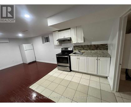 A kitchen with white cabinets and a black stove top oven.