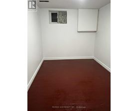 A room with a window and a white board on the wall.
