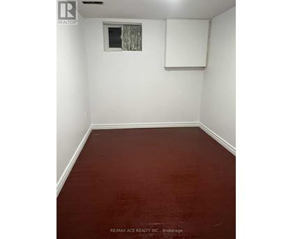 A room with a window and a white board on the wall.