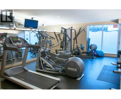 A gym with treadmills, exercise bikes and other equipment.