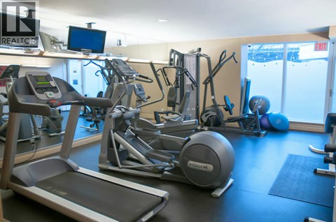 A gym with treadmills, exercise bikes and other equipment.