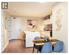A kitchen with a table and chairs and a painting on the wall.