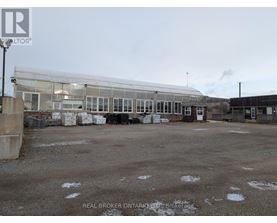 A large, empty parking lot with a building in the background.