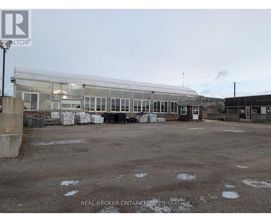 A large, empty parking lot with a building in the background.