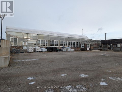 A large, empty parking lot with a building in the background.
