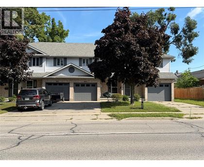 A house with a car parked in front of it.