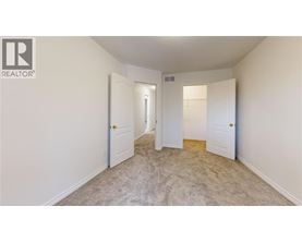 A realtor logo is on the wall of a white room.