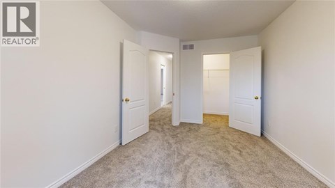 A realtor logo is on the wall of a white room.